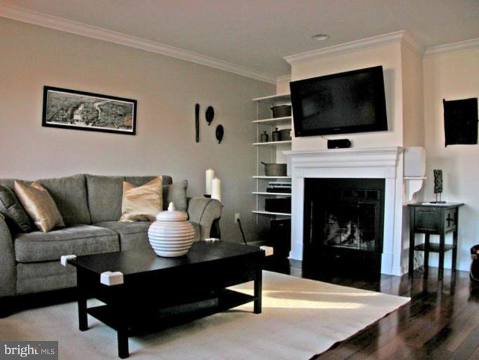 724 West Glebe Road Alexandria, VA 22305 - Photo 3 of 20 a living room with furniture a flat screen tv and a fireplace