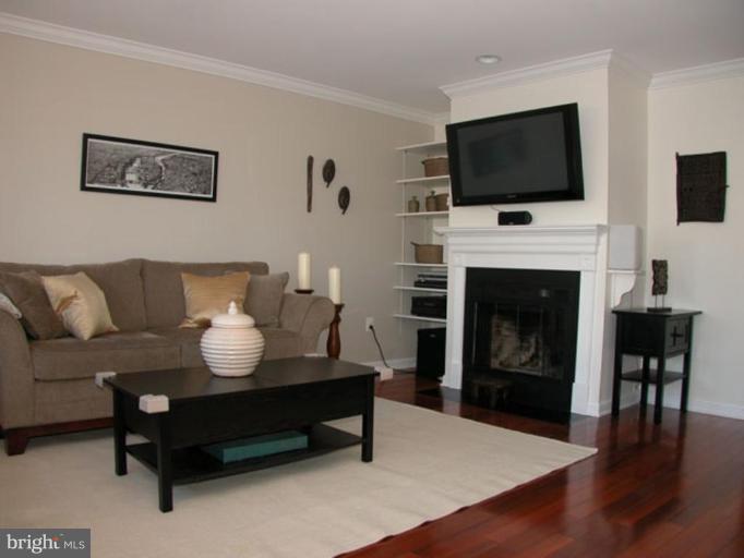 724 West Glebe Road Alexandria, VA 22305 - Photo 4 of 20 a living room with furniture a fireplace and a flat screen tv