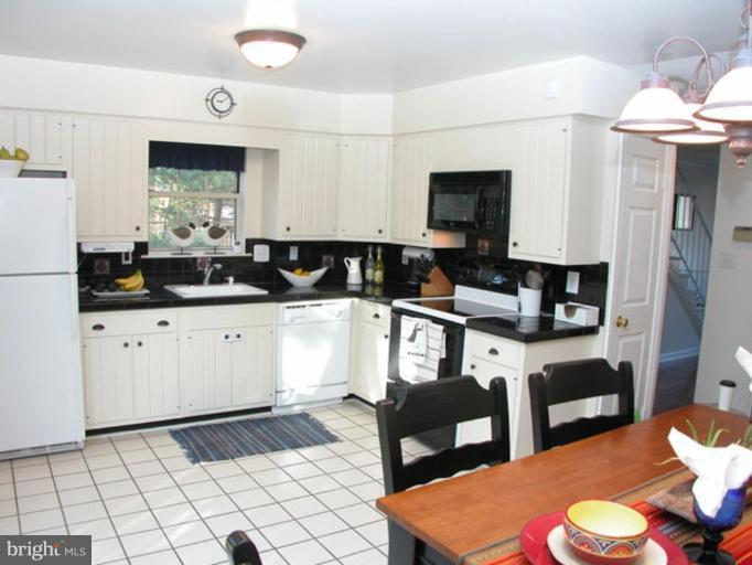 724 West Glebe Road Alexandria, VA 22305 - Photo 6 of 20 a kitchen with granite countertop a sink cabinets and stainless steel appliances