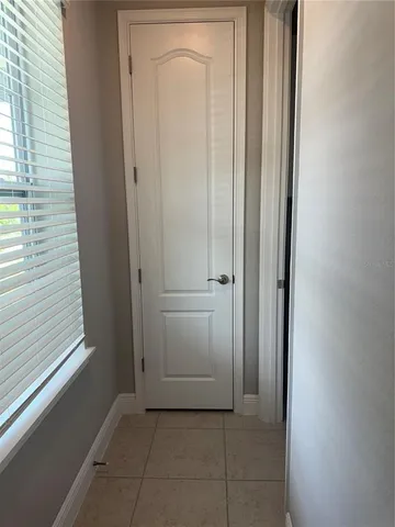 a view of a hallway with closet and door