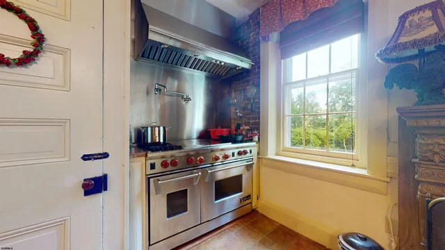 a view of an entryway wooden floor and a rug