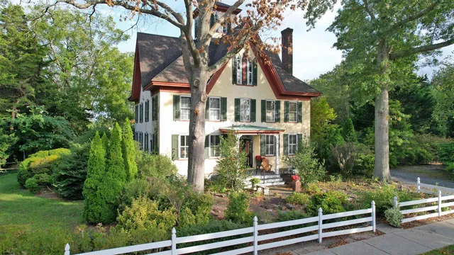 an aerial view of a house with a small yard and large trees