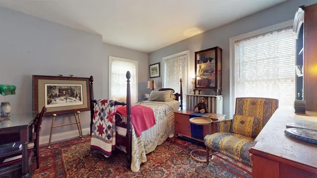 a view of a backyard with potted plants and large tree