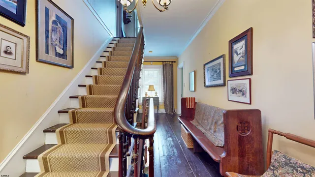 a view of a backyard with table and chairs potted plants and palm trees