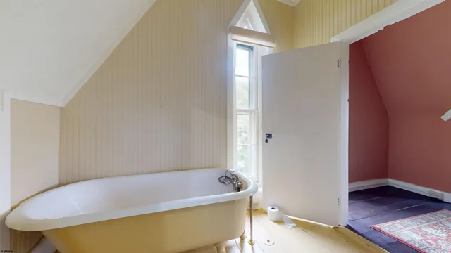 an aerial view of a house with a yard and lake view