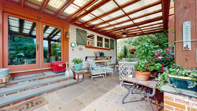 an aerial view of a house with a yard and parking spaces