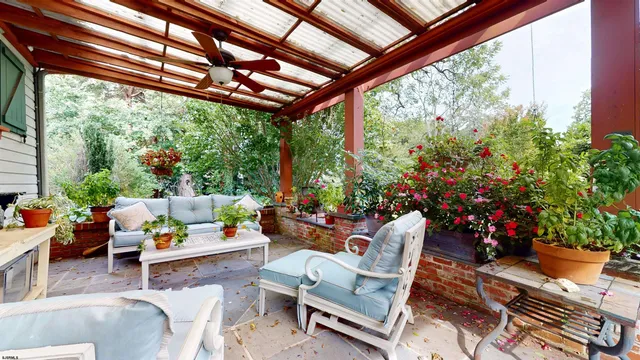an aerial view of lake residential house with outdoor space and trees all around