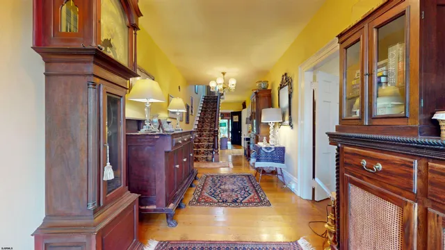 a view of a dining room with furniture a chandelier and wooden floor