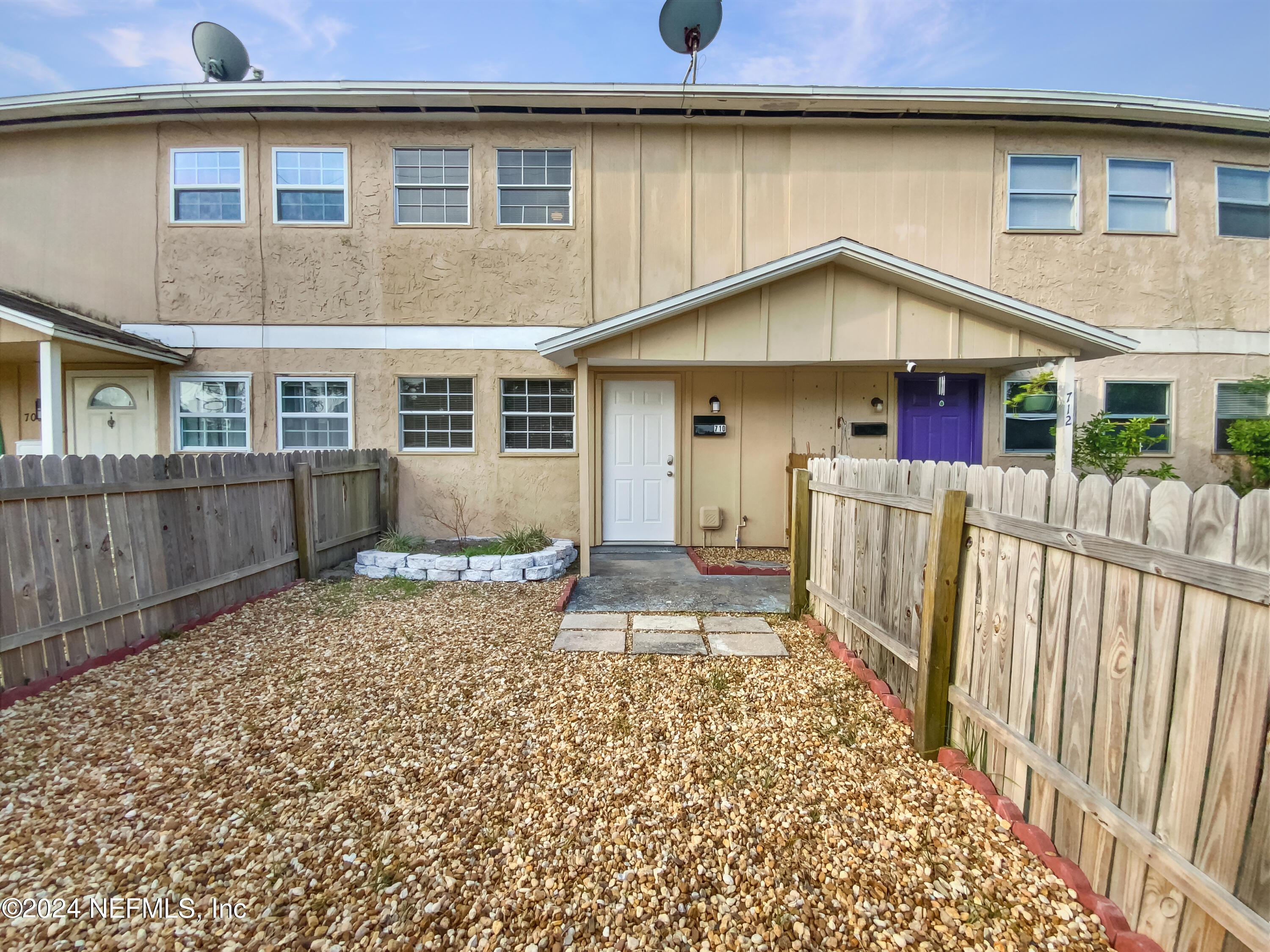 a front view of a house with a yard and wooden floor