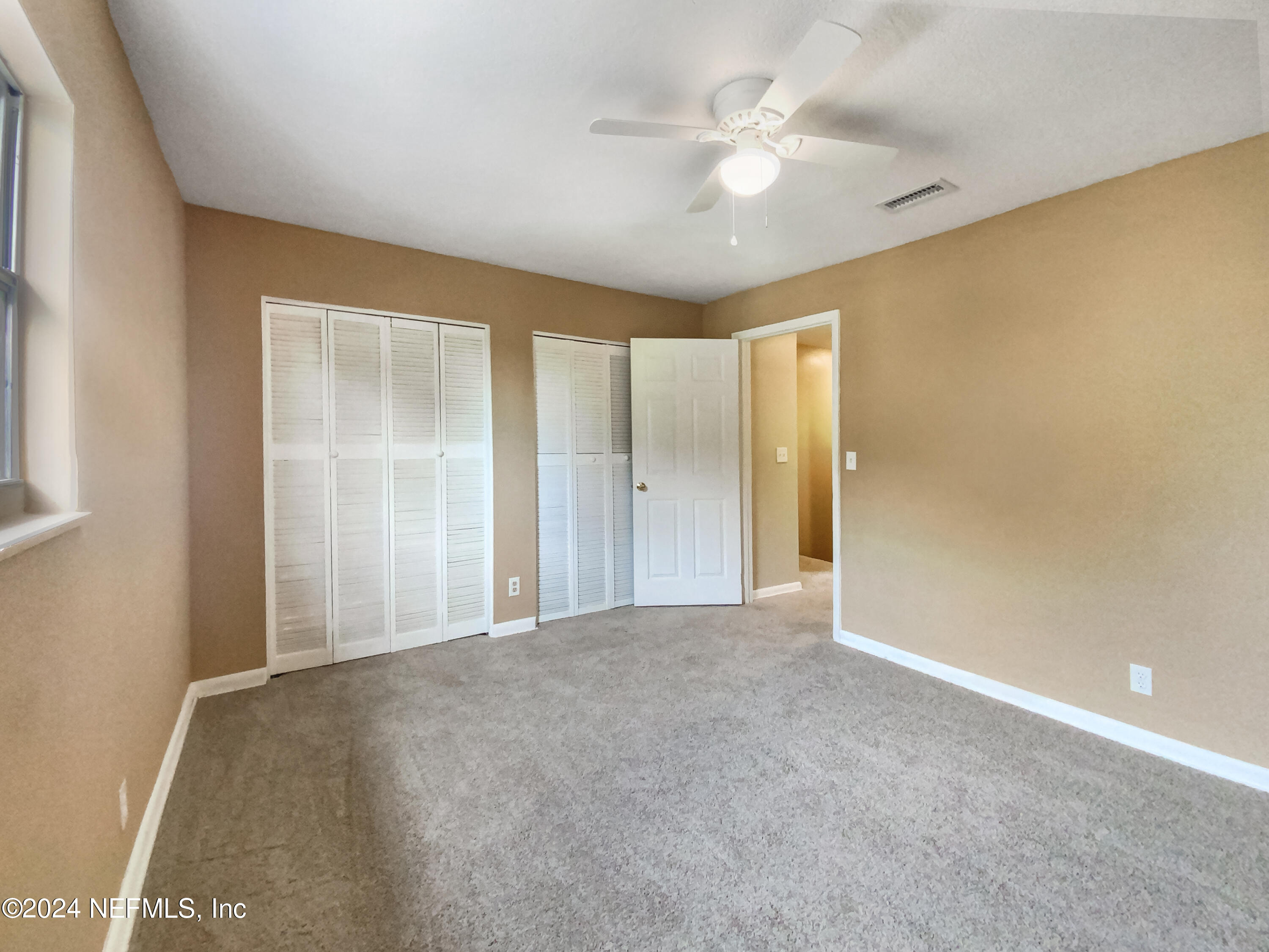 710 Cavalla Road Atlantic Beach, FL 32233 - Photo 12 of 17 a view of an empty room with a chandelier fan