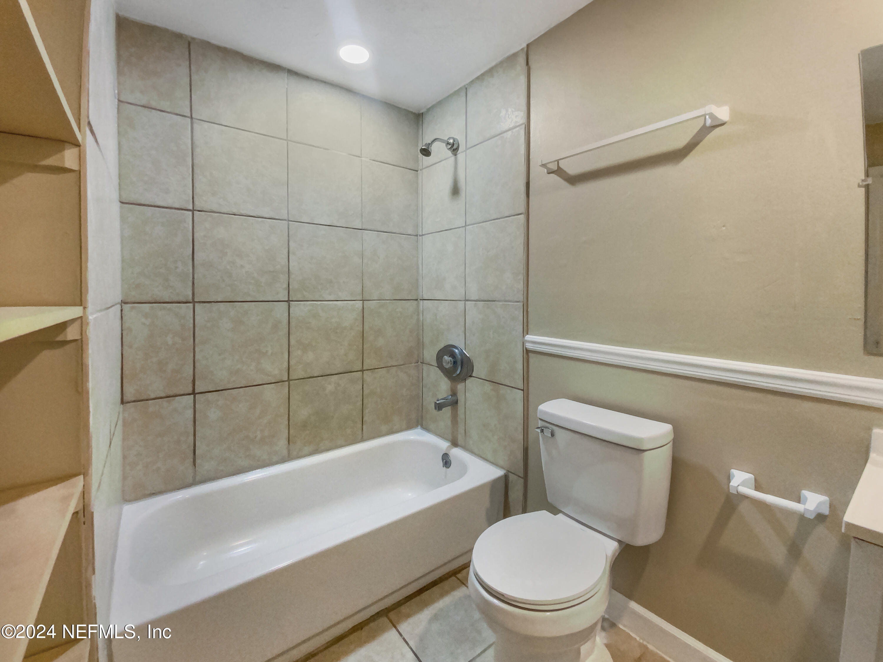 710 Cavalla Road Atlantic Beach, FL 32233 - Photo 15 of 17 a white toilet and tub sitting next to a bathroom sink