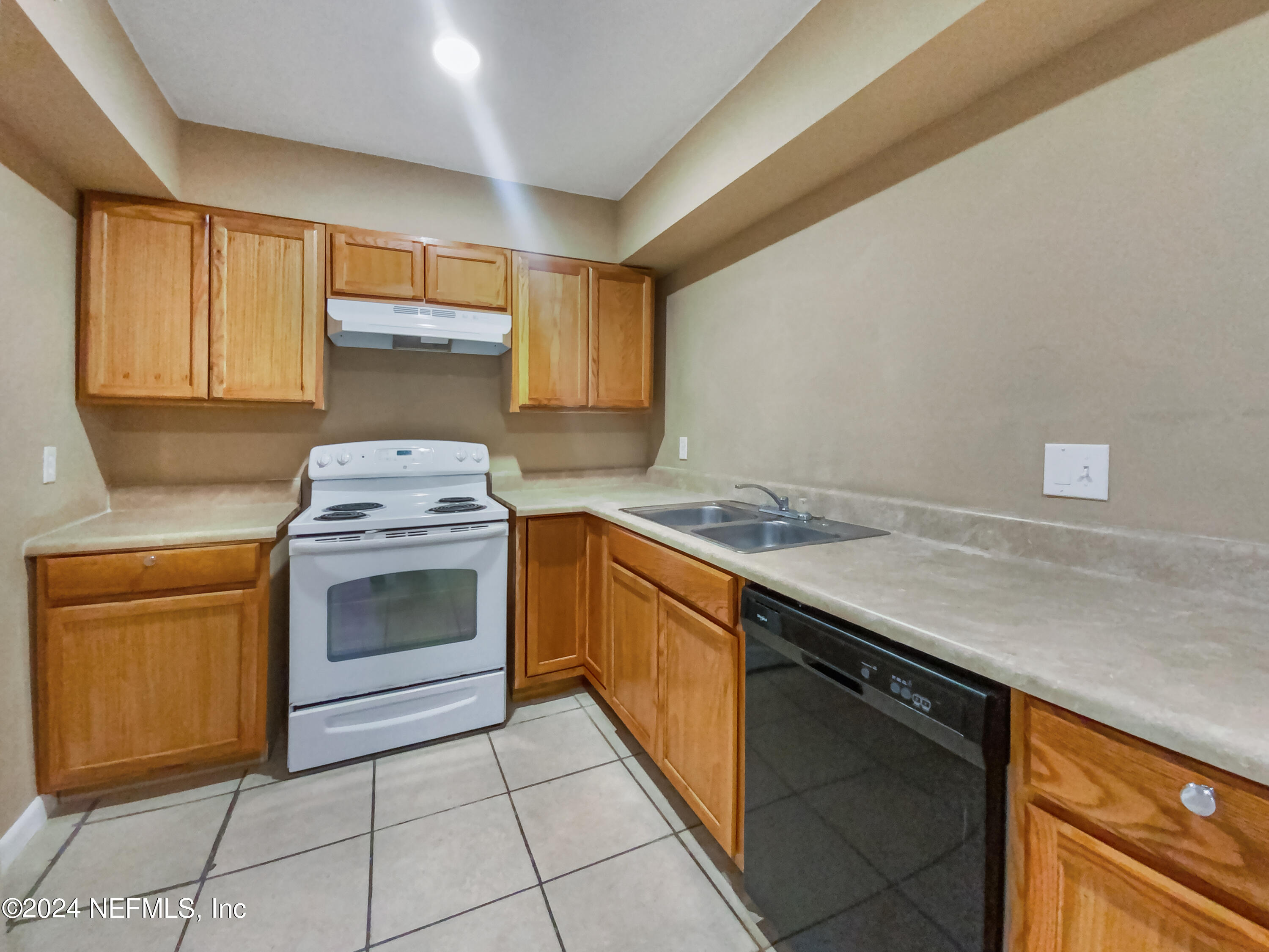 710 Cavalla Road Atlantic Beach, FL 32233 - Photo 2 of 17 a kitchen with a stove sink and cabinets
