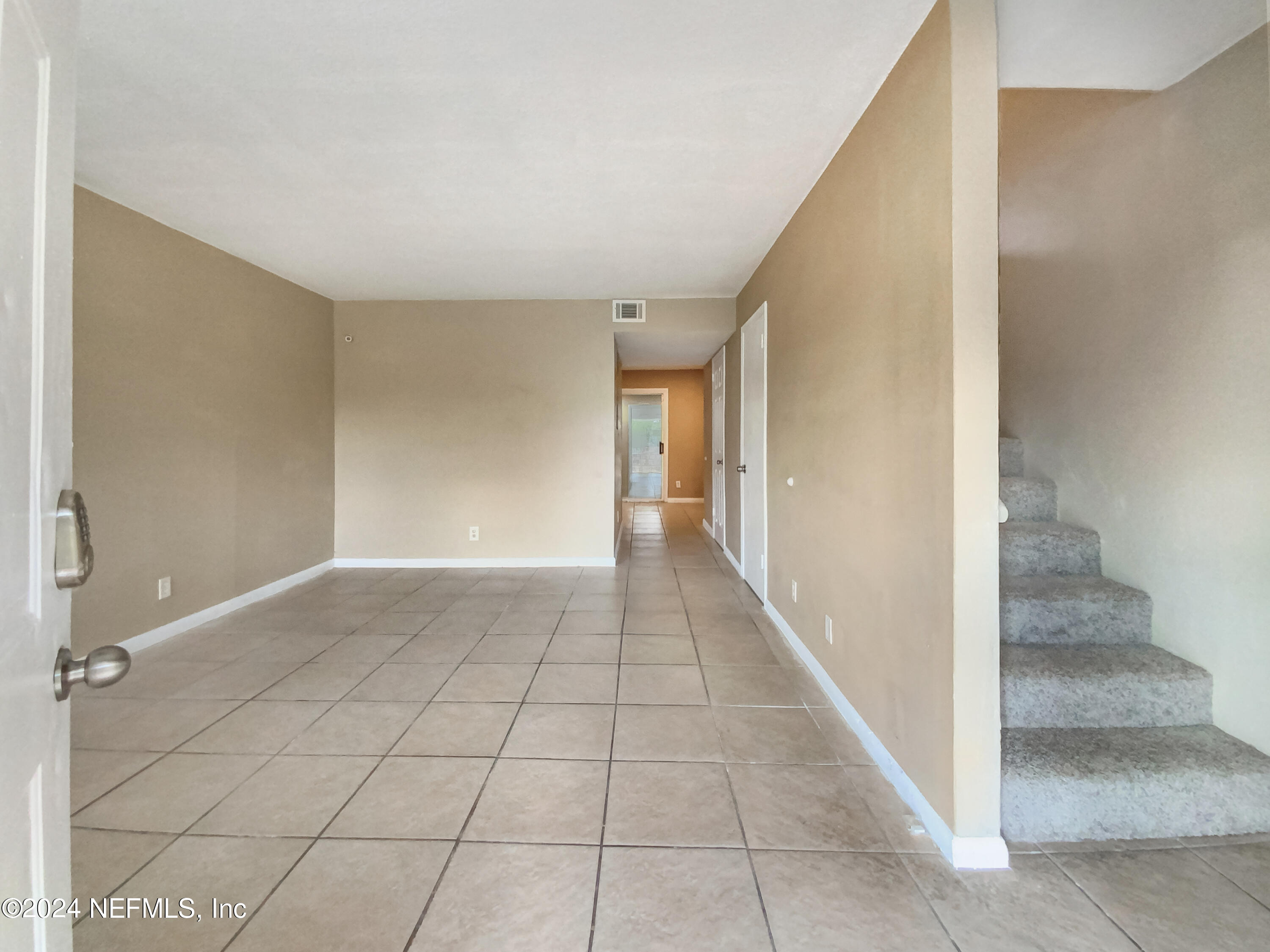 710 Cavalla Road Atlantic Beach, FL 32233 - Photo 4 of 17 a view of a hallway to an empty room with entrance