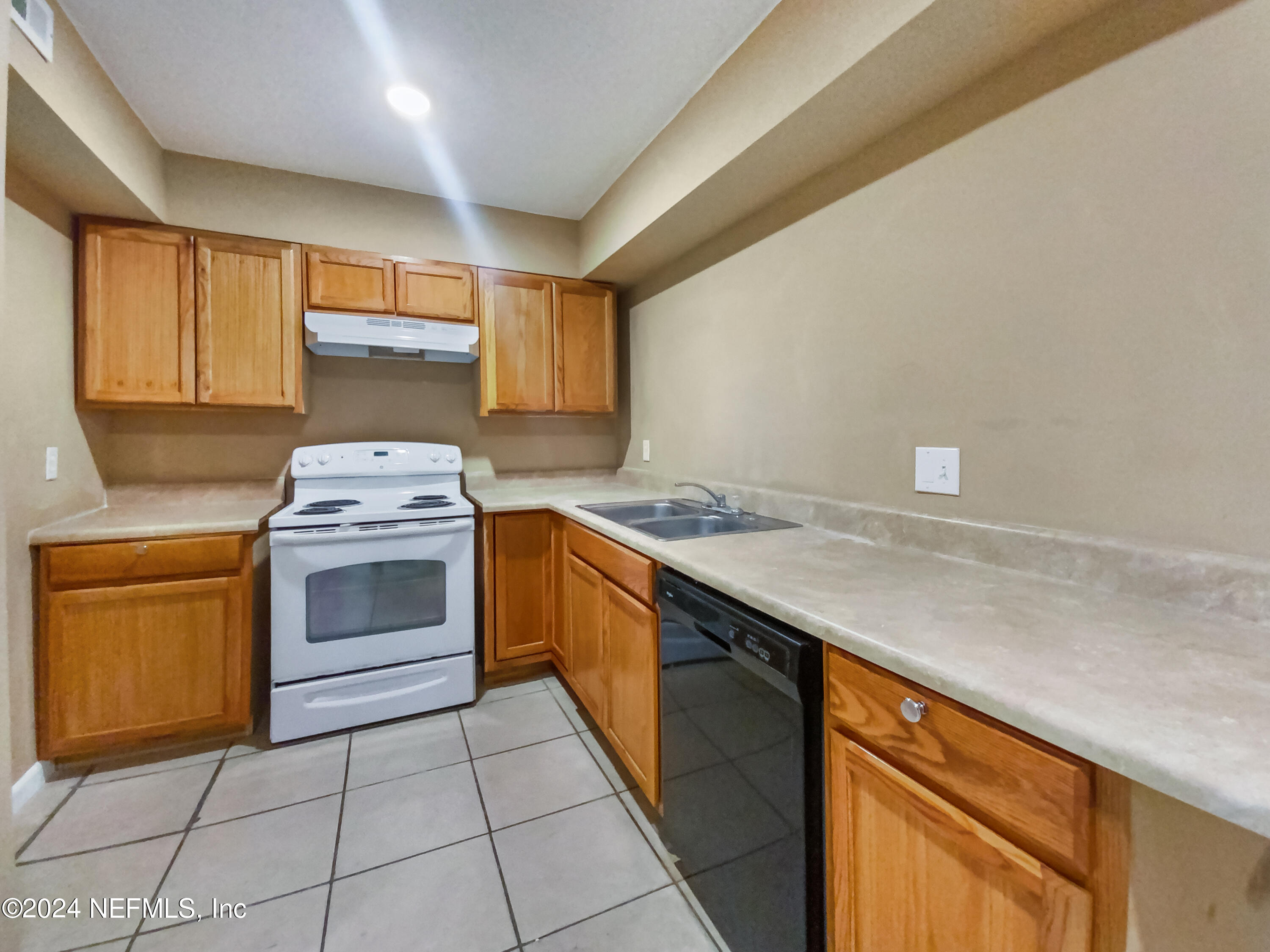 710 Cavalla Road Atlantic Beach, FL 32233 - Photo 8 of 17 a kitchen with a stove sink and cabinets