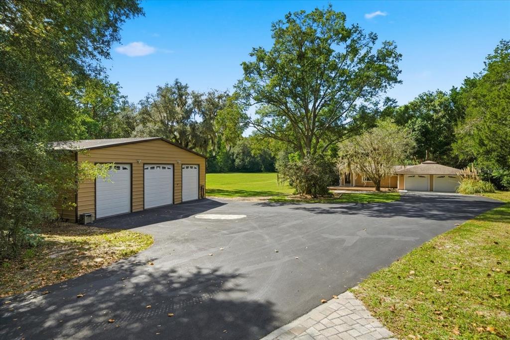 22063 Lake Lindsey Road Brooksville, FL 34601 - Photo 1 of 1 a front view of a house with a yard and garage