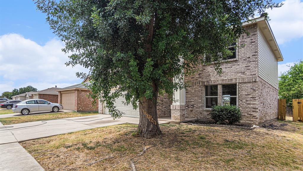 8732 Hunters Point Way Fort Worth, TX 76123 - Photo 3 of 24 a view of a car parked in front of a brick house