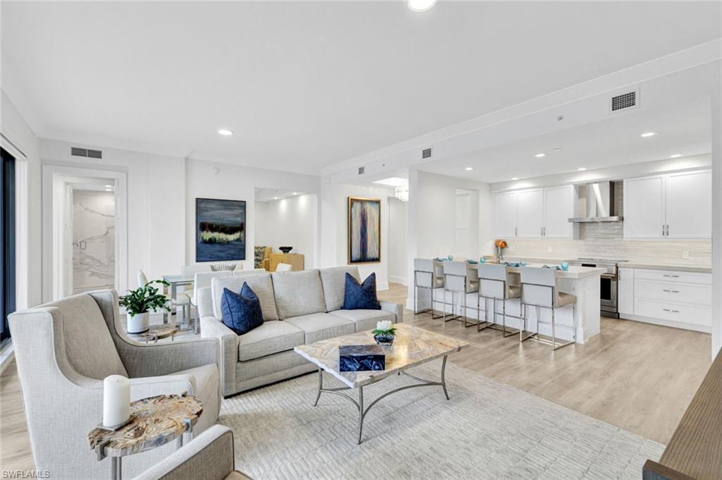 a living room with furniture kitchen view and a table