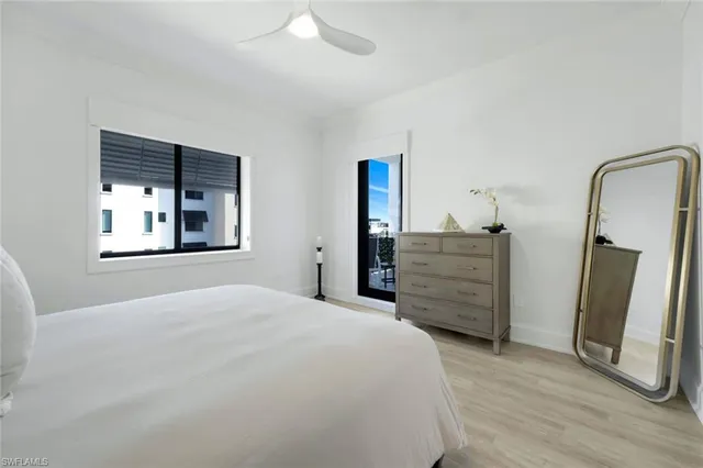 a spacious bathroom with a granite countertop sink mirror and bathtub