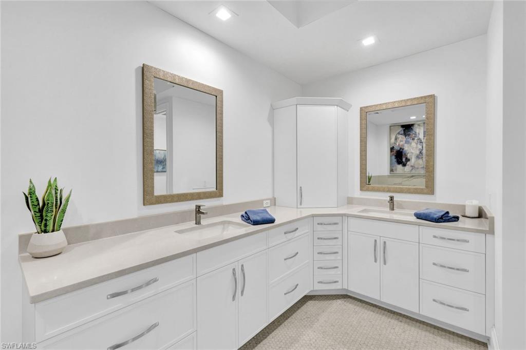 1030 3rd Avenue South, Unit 419 Naples, FL 34102 - Photo 12 of 29 a bathroom with double sink and a mirror
