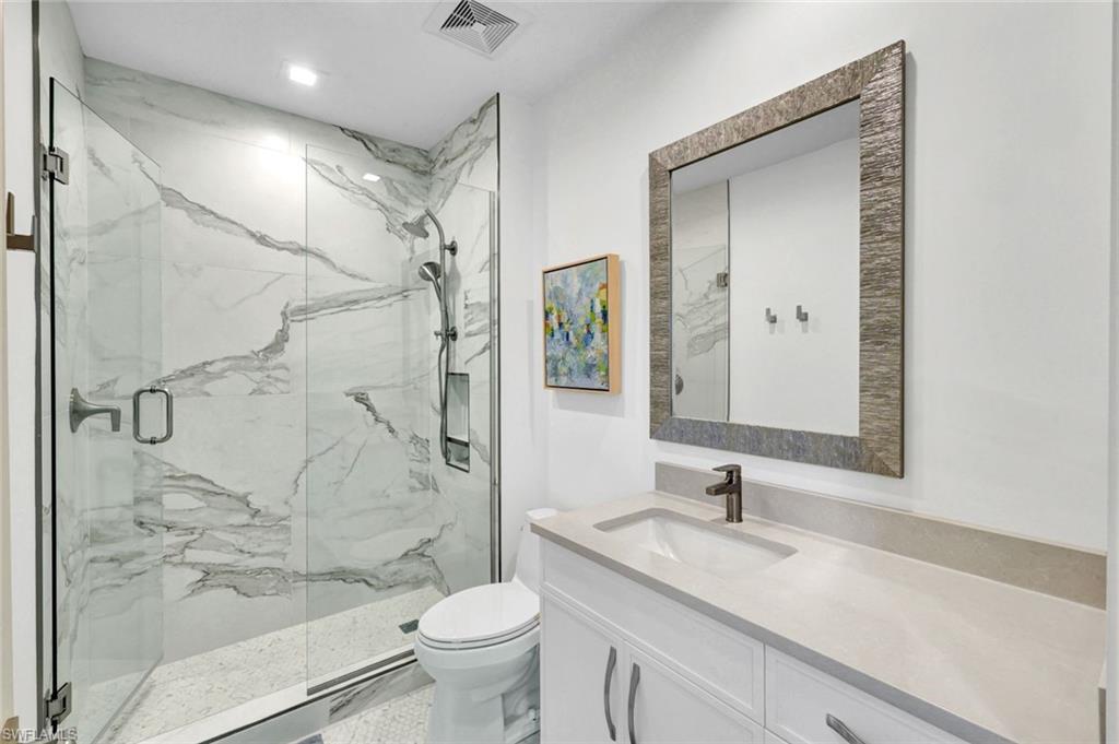 1030 3rd Avenue South, Unit 419 Naples, FL 34102 - Photo 14 of 29 a bathroom with a granite countertop sink toilet and shower