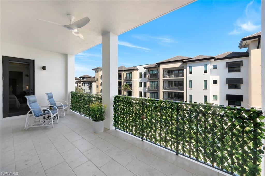 1030 3rd Avenue South, Unit 419 Naples, FL 34102 - Photo 17 of 29 a view of a chairs and table in a patio