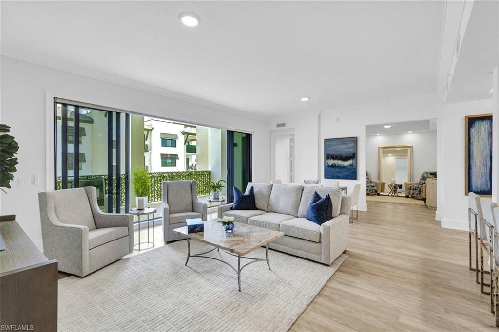 1030 3rd Avenue South, Unit 419 Naples, FL 34102 - Photo 2 of 29 a living room with furniture and a large window