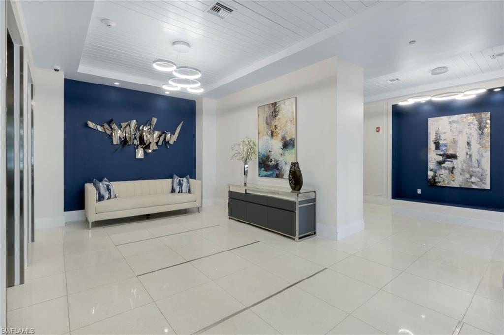 1030 3rd Avenue South, Unit 419 Naples, FL 34102 - Photo 22 of 29 a bedroom with furniture and a painting on the wall