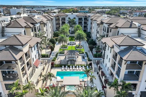 an aerial view of multiple houses with a yard