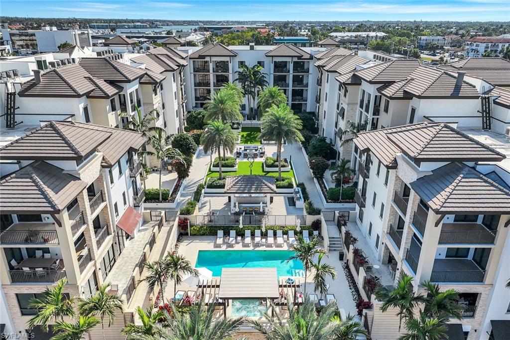 1030 3rd Avenue South, Unit 419 Naples, FL 34102 - Photo 24 of 29 an aerial view of multiple houses with a yard