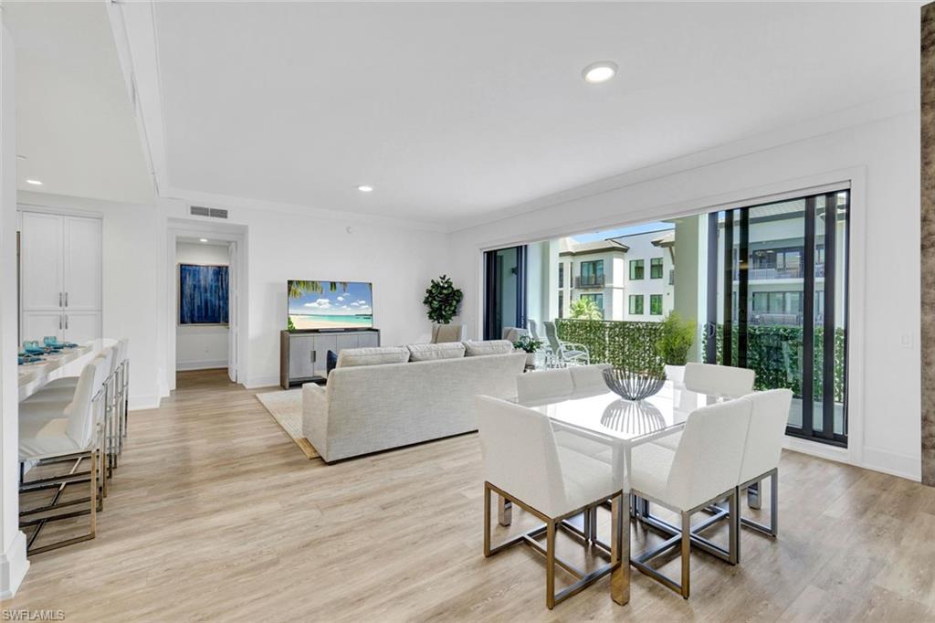 1030 3rd Avenue South, Unit 419 Naples, FL 34102 - Photo 3 of 29 a living room with furniture and a large window