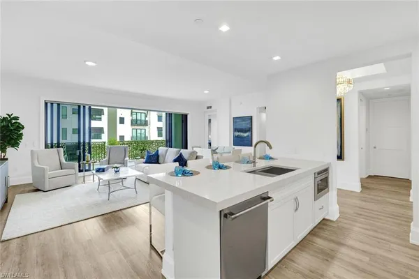 a large kitchen with kitchen island a sink and a large window
