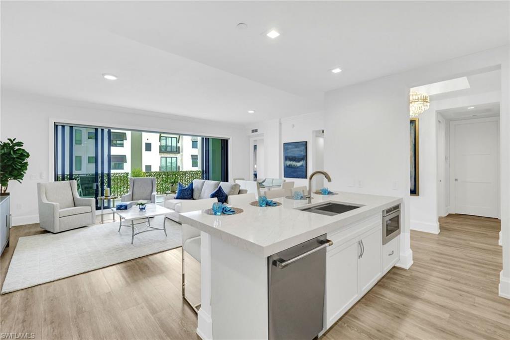 1030 3rd Avenue South, Unit 419 Naples, FL 34102 - Photo 4 of 29 a large kitchen with kitchen island a sink and a large window