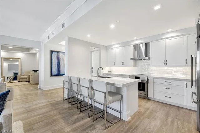 a kitchen with a sink a stove a refrigerator and cabinets
