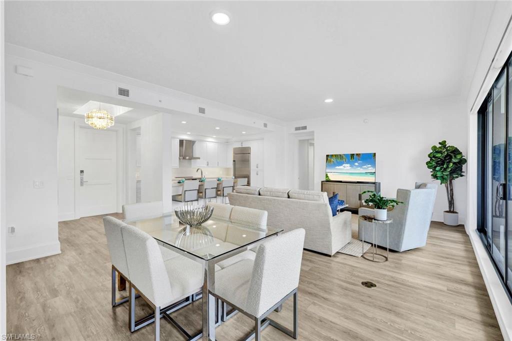 1030 3rd Avenue South, Unit 419 Naples, FL 34102 - Photo 7 of 29 a dining room with furniture and wooden floor