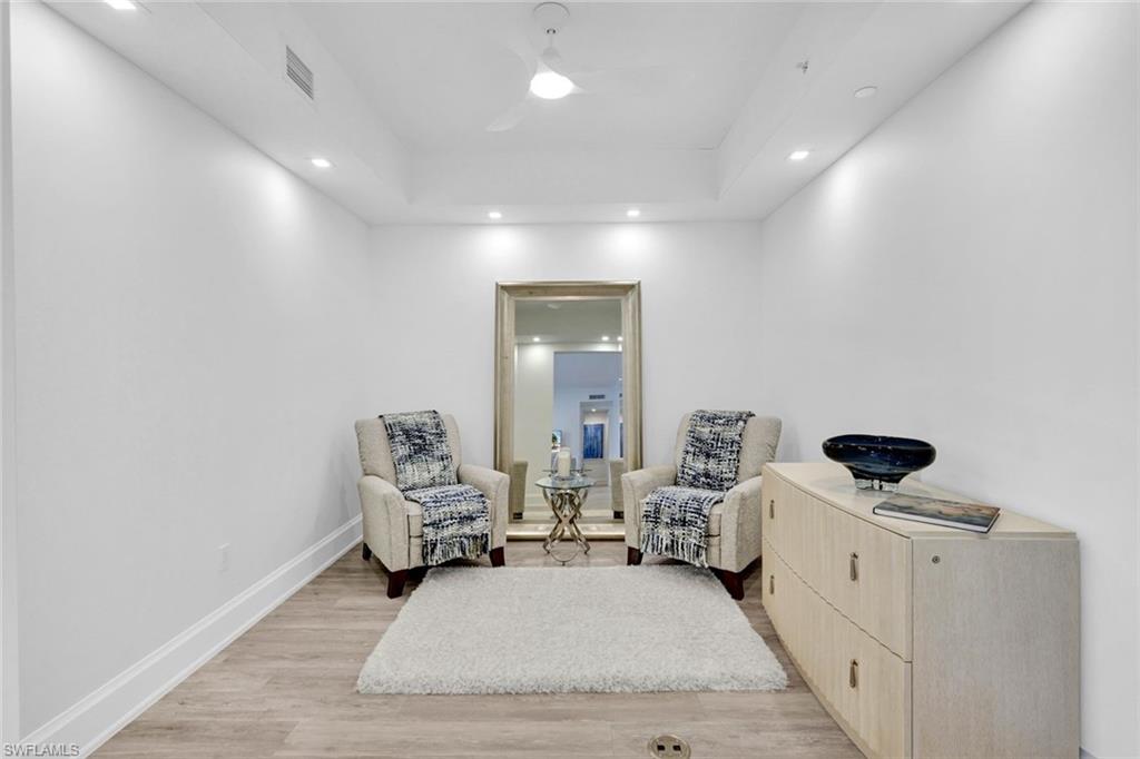 1030 3rd Avenue South, Unit 419 Naples, FL 34102 - Photo 8 of 29 a living room with furniture and a flat screen tv
