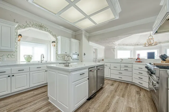 a view of a kitchen with sink cabinets and wooden floor