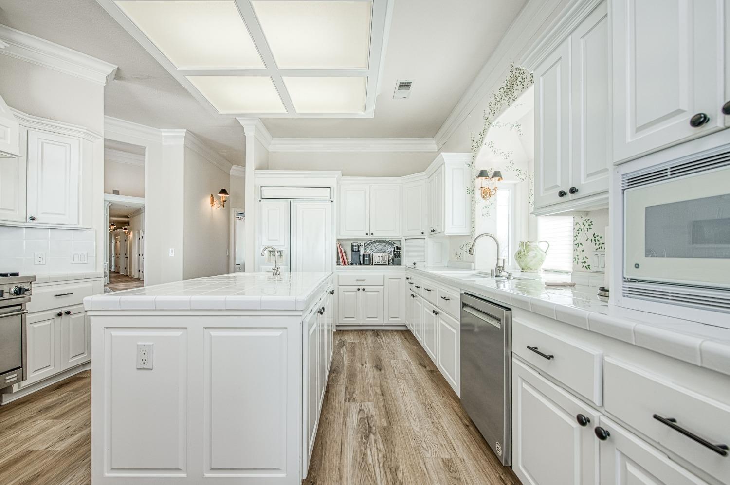 18300 Watts Valley Road Sanger, CA 93657 - Photo 23 of 78 a large white kitchen with cabinets