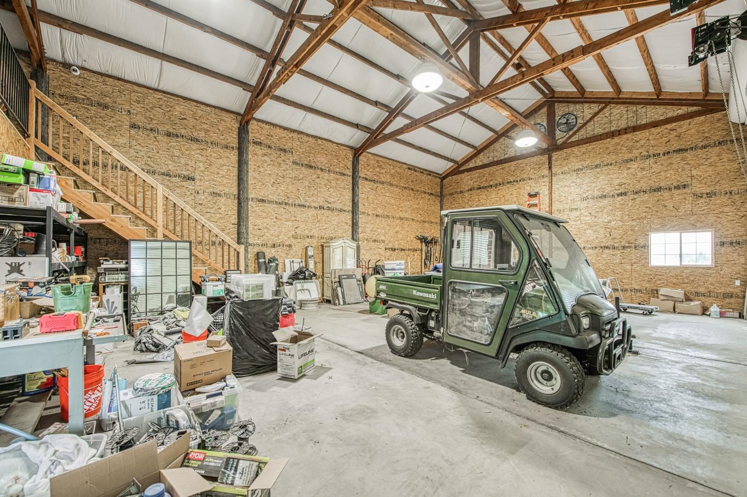 18300 Watts Valley Road Sanger, CA 93657 - Photo 59 of 78 a car and bike parked in a garage