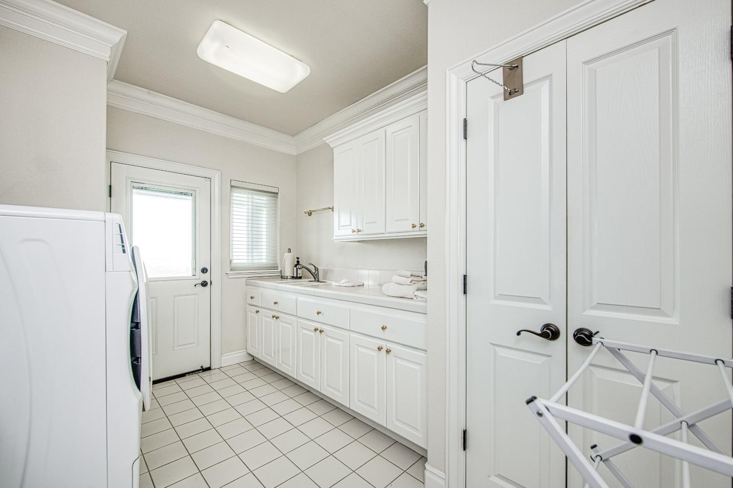 18300 Watts Valley Road Sanger, CA 93657 - Photo 62 of 78 a view of a kitchen with sink cabinets and wooden floor