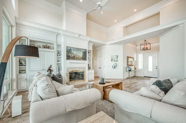 a large white kitchen with cabinets