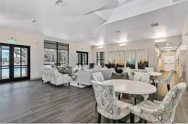 a kitchen with granite countertop a dining table chairs and a chandelier