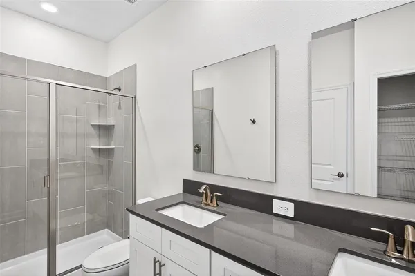 a kitchen with stainless steel appliances granite countertop a refrigerator a sink and a stove
