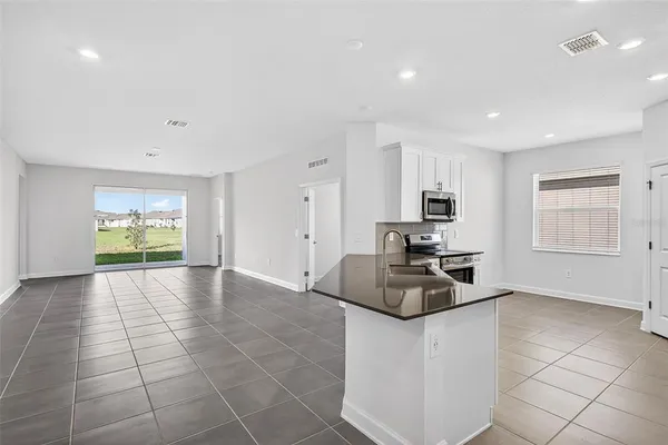 a kitchen with stainless steel appliances a refrigerator stove and sink