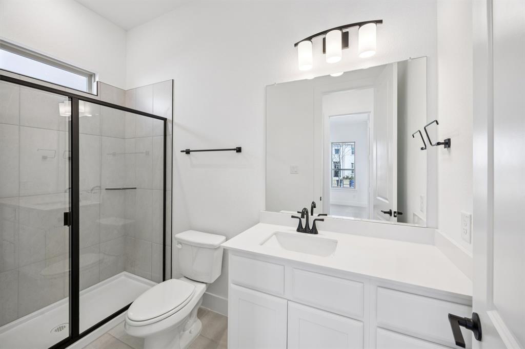 3412 Aldrich Road McKinney, TX 75071 - Photo 12 of 38 a bathroom with a sink a toilet and shower