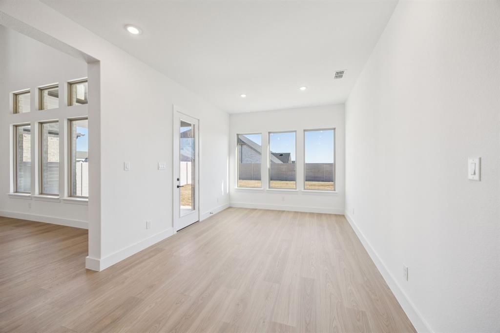 3412 Aldrich Road McKinney, TX 75071 - Photo 17 of 38 an empty room with wooden floor and windows