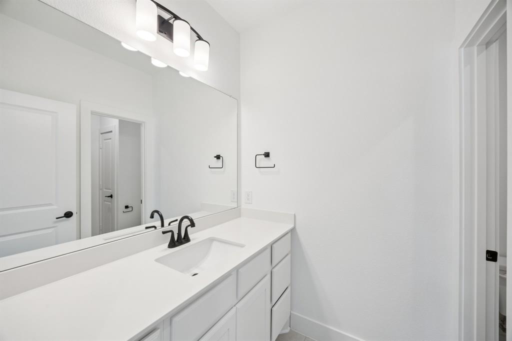 3412 Aldrich Road McKinney, TX 75071 - Photo 26 of 38 a bathroom with a sink and a mirror