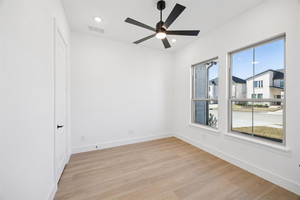 3412 Aldrich Road McKinney, TX 75071 - Photo 9 of 38 an empty room with wooden floor and windows