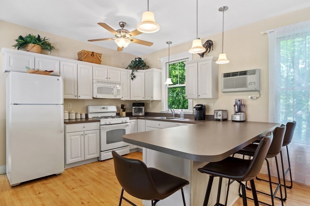 a kitchen with a dining table chairs sink and cabinets