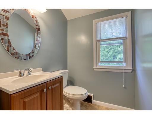 72 Burt Road Springfield, MA 01118 - Photo 12 of 19 a bathroom with a toilet a sink a mirror and a window
