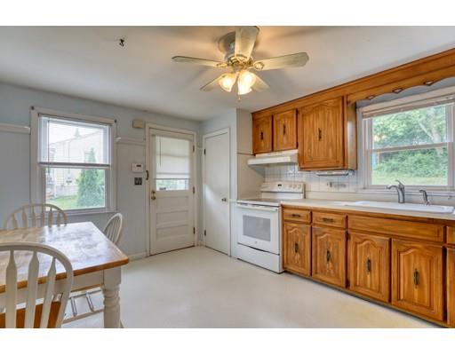 72 Burt Road Springfield, MA 01118 - Photo 3 of 19 a open kitchen with stainless steel appliances granite countertop a stove top oven a sink dishwasher and cabinets with wooden floor